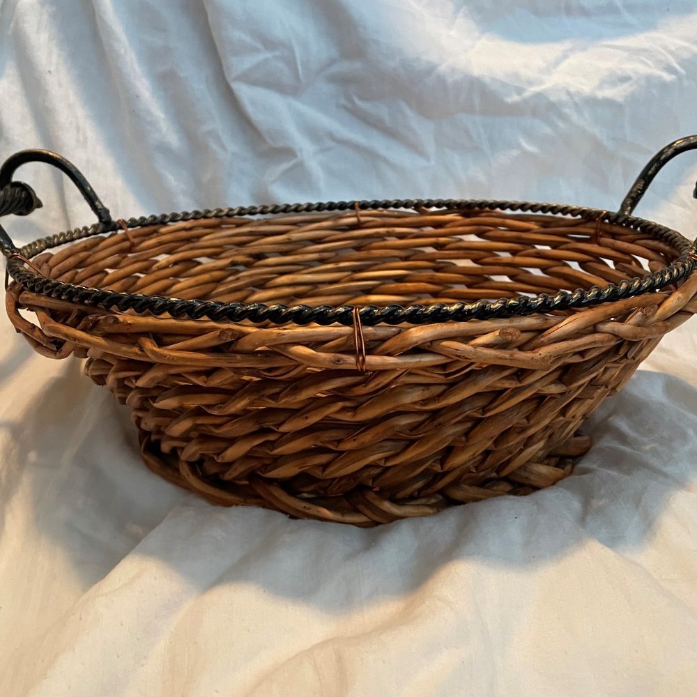 Woven basket with metal rim and handles